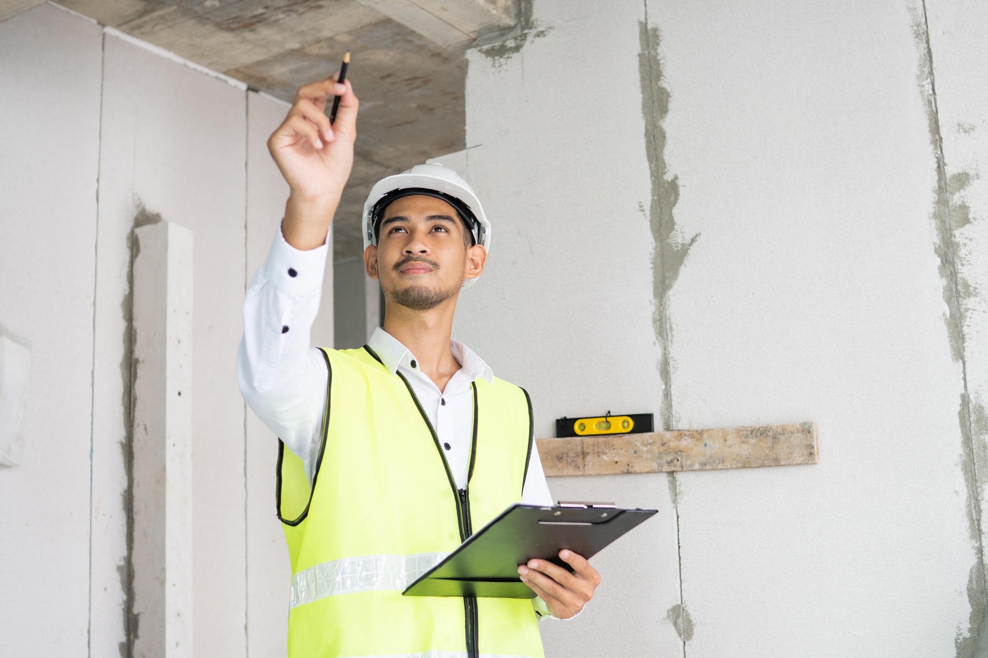 Inspector holding clipboard opening paper and checking building for renovation, Home inspection